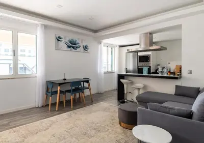 a living room with a couch and a table at Lovely 1-bedroom apartment with parking ocean view in Funchal