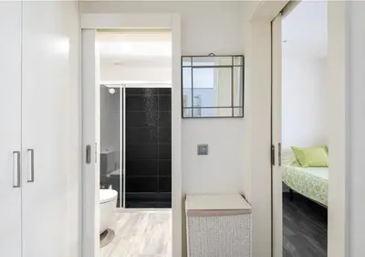 a bathroom with a door leading to a bedroom at Lovely 1-bedroom apartment with parking ocean view in Funchal