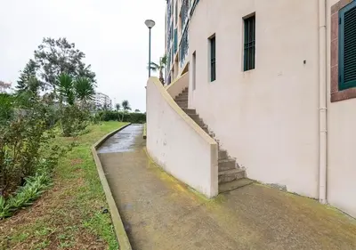 a stairway leading up to a building with a stair case at Lovely 1-bedroom apartment with parking ocean view in Funchal