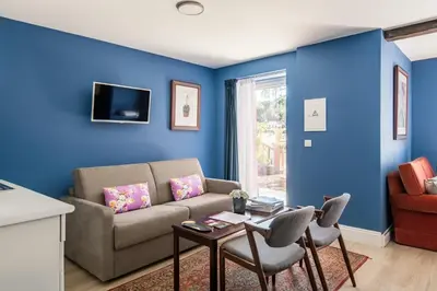 a blue living room with a couch and a table at Villa Camélia Boutique House in Camacha