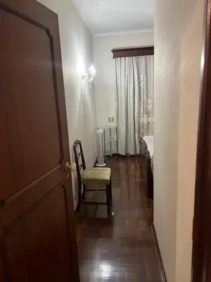 a hallway with a room with a chair and a door at Angie’s apartment in Funchal