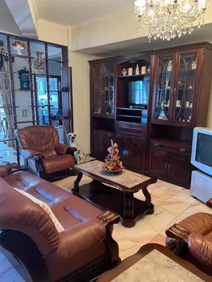 a living room with a couch and a table and a tv at Angie’s apartment in Funchal