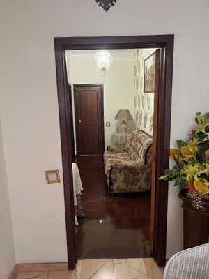 a hallway with a door leading to a living room at Angie’s apartment in Funchal