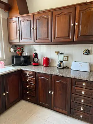 a kitchen with wooden cabinets and a blender on the counter at Angie’s apartment in Funchal