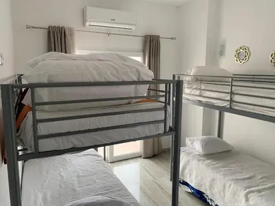 two bunk beds in a room with a window at ORANGE guest house in Sagres