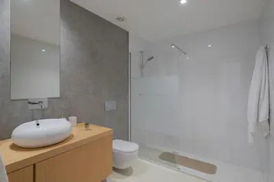 a bathroom with a white sink and a toilet at Villa das Quebradas by An Island Apart in Funchal