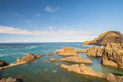 a view of the ocean with rocks in the water at Porto Moniz City Centre by Homie in Porto Moniz