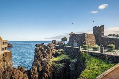 a view of the ocean and a castle at Porto Moniz City Centre by Homie in Porto Moniz