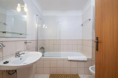 a bathroom with a sink and a bath tub at Porto Moniz City Centre by Homie in Porto Moniz
