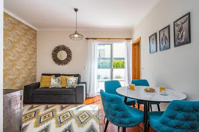 a living room with a couch and a table and chairs at Porto Moniz City Centre by Homie in Porto Moniz