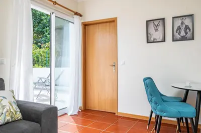 a living room with a door and a table and chairs at Porto Moniz City Centre by Homie in Porto Moniz