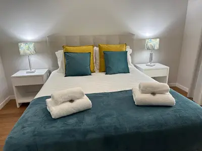 a bedroom with a large bed with two lamps at Ines Seaview Apartment in Funchal