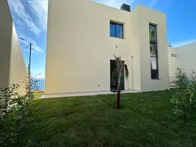 a white house with a green yard at Ines Seaview Apartment in Funchal