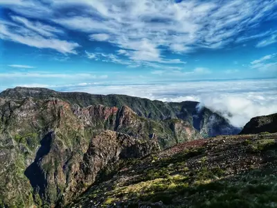 a view of a mountain range with clouds in the background at Ines Seaview Apartment in Funchal