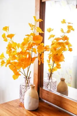 three vases with yellow flowers sitting on a window sill at Arrifana Beach House - T2 Haller in Aljezur