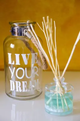 a jar with the words hug your dream written on it next to a vase at Arrifana Beach House - T2 Haller in Aljezur