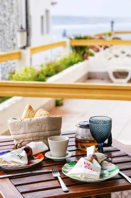 a table with plates of food on top of it at Arrifana Beach House - T2 Haller in Aljezur