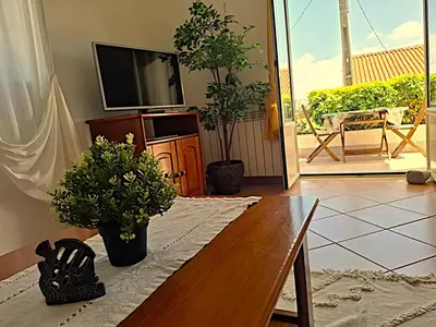 a room with two beds and a picture of a car on the wall at Arrifana Beach- T2 Sun & Surf Flat in Aljezur