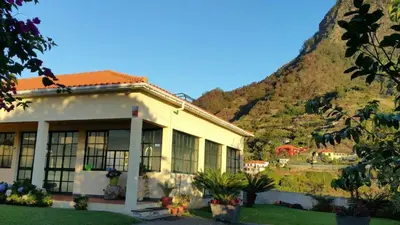 a house with a mountain in the background at House pc in Porto da Cruz