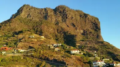 a mountain with houses on the side of it at House pc in Porto da Cruz