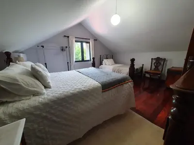 a bedroom with a large white bed in a attic at Mountain-Ocean-View Madeira in São Vicente