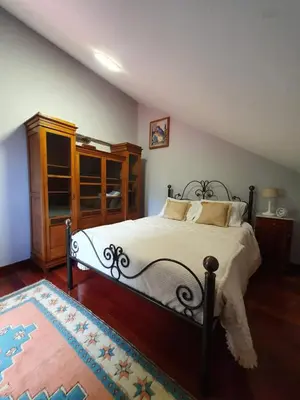 a bedroom with a bed and a wooden cabinet at Mountain-Ocean-View Madeira in São Vicente