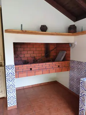 a brick fireplace in a room with a tile floor at Mountain-Ocean-View Madeira in São Vicente