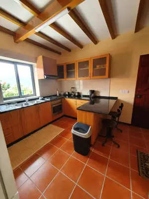 a kitchen with a counter and a table in it at Mountain-Ocean-View Madeira in São Vicente