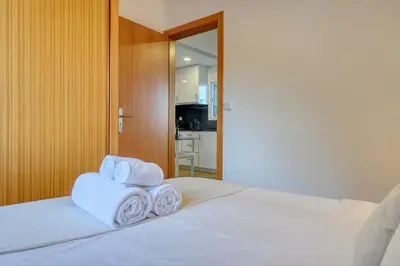 a bedroom with a bed with towels on it at Casa Familia Pestana 2, a Home in Madeira in Seixal
