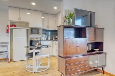 a kitchen with a entertainment center with a tv on top at Casa Familia Pestana 2, a Home in Madeira in Seixal