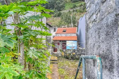 a small building with an orange roof on a mountain at Casa Familia Pestana 2, a Home in Madeira in Seixal