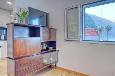 a large wooden entertainment center with a tv on top at Casa Familia Pestana 2, a Home in Madeira in Seixal