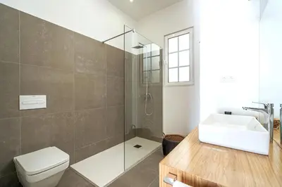 a bathroom with a toilet and a sink and a shower at Villa Carvalhal in Funchal