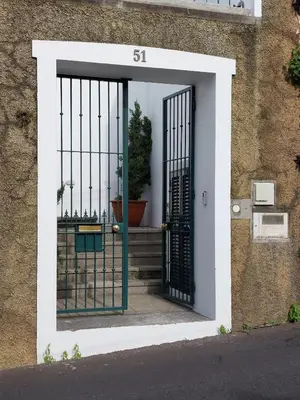 an entrance to a building with a black gate at Villa Carvalhal in Funchal