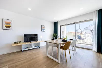 a dining room with a table and a large window at The Kuuyi Suite in Burgau
