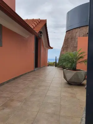 a patio outside of a house with the ocean in the background at Ocean View Madeira 1 - Ponta do Sol in Canhas