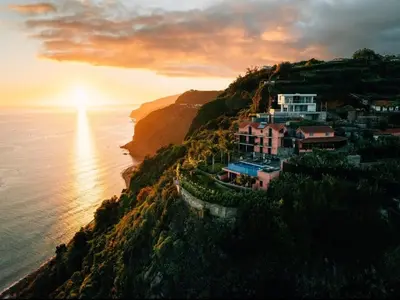 a house on top of a hill next to the ocean at Ocean View Madeira 1 - Ponta do Sol in Canhas