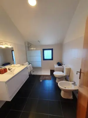 a large bathroom with two toilets and a sink at Ocean View Madeira 1 - Ponta do Sol in Canhas