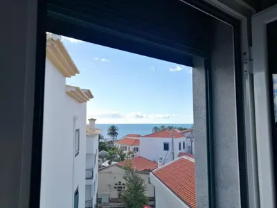 a window view of the ocean from a building at Duplex da Fontinha in Santa Cruz