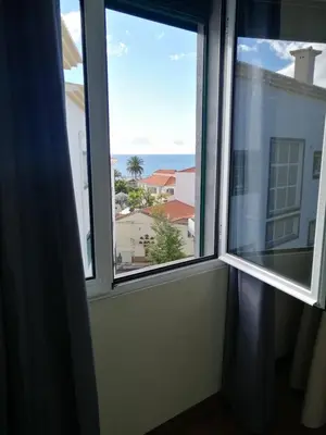 a window with a view of the ocean at Duplex da Fontinha in Santa Cruz