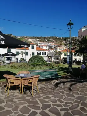 a picnic table and a bench in a park at Duplex da Fontinha in Santa Cruz