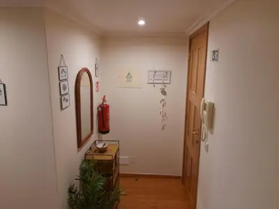 a hallway with a room with a mirror and a door at Duplex da Fontinha in Santa Cruz