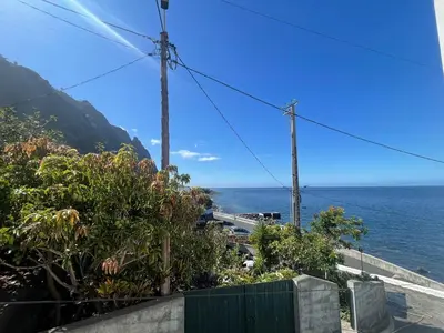 a view of the ocean from a balcony at MAKTUB SUNSET COTTAGE A in Paul do Mar