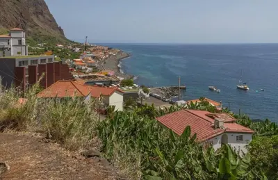 a town on a hill next to the ocean at MAKTUB SUNSET COTTAGE A in Paul do Mar