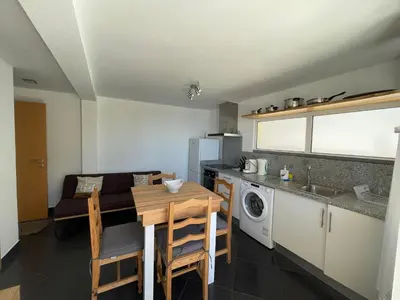 a kitchen with a table and a dining room at MAKTUB SUNSET COTTAGE A in Paul do Mar