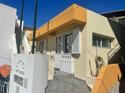 a house with a gate and stairs in front of it at MAKTUB SUNSET COTTAGE A in Paul do Mar