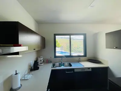 a small kitchen with a sink and a window at Villa Camacho xxvii in Arco da Calheta