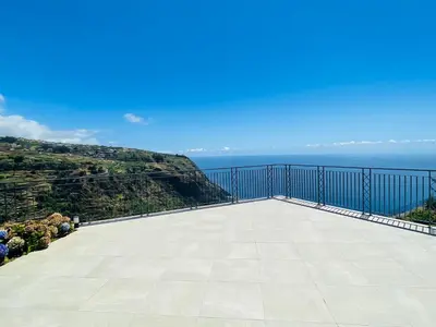 a large balcony with a view of the ocean at Villa Camacho xxvii in Arco da Calheta