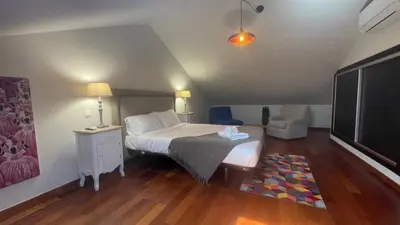 a bedroom with a bed and a painting on the wall at Villa Camacho xxvii in Arco da Calheta