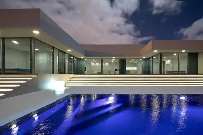 an empty house with a swimming pool at night at Villa Camacho - Ultra Luxury in Calheta